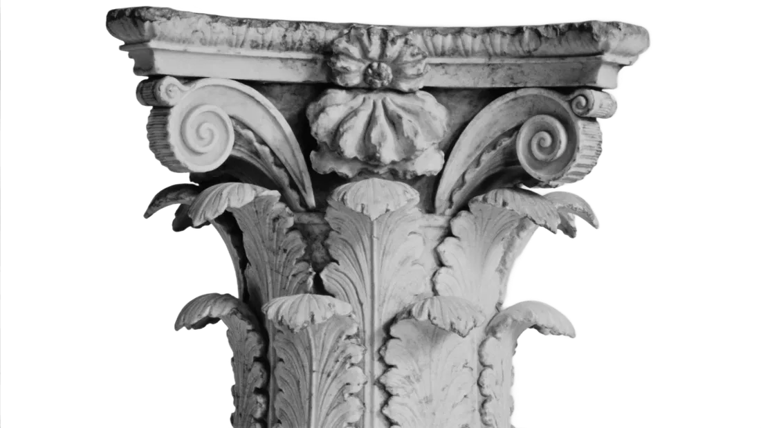 Weathered Corinthian capital with curling volutes and acanthus leaves